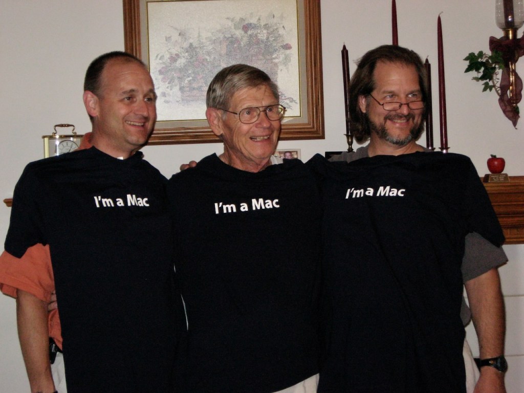 Portrait photo of three guys with “I’m a Mac” T-shirts.